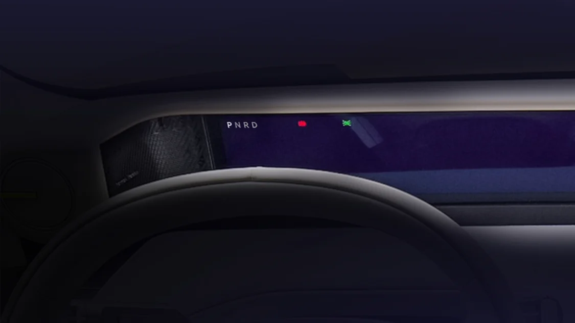 Freelander 8 cockpit view through steering wheel showing panoramic display in low light